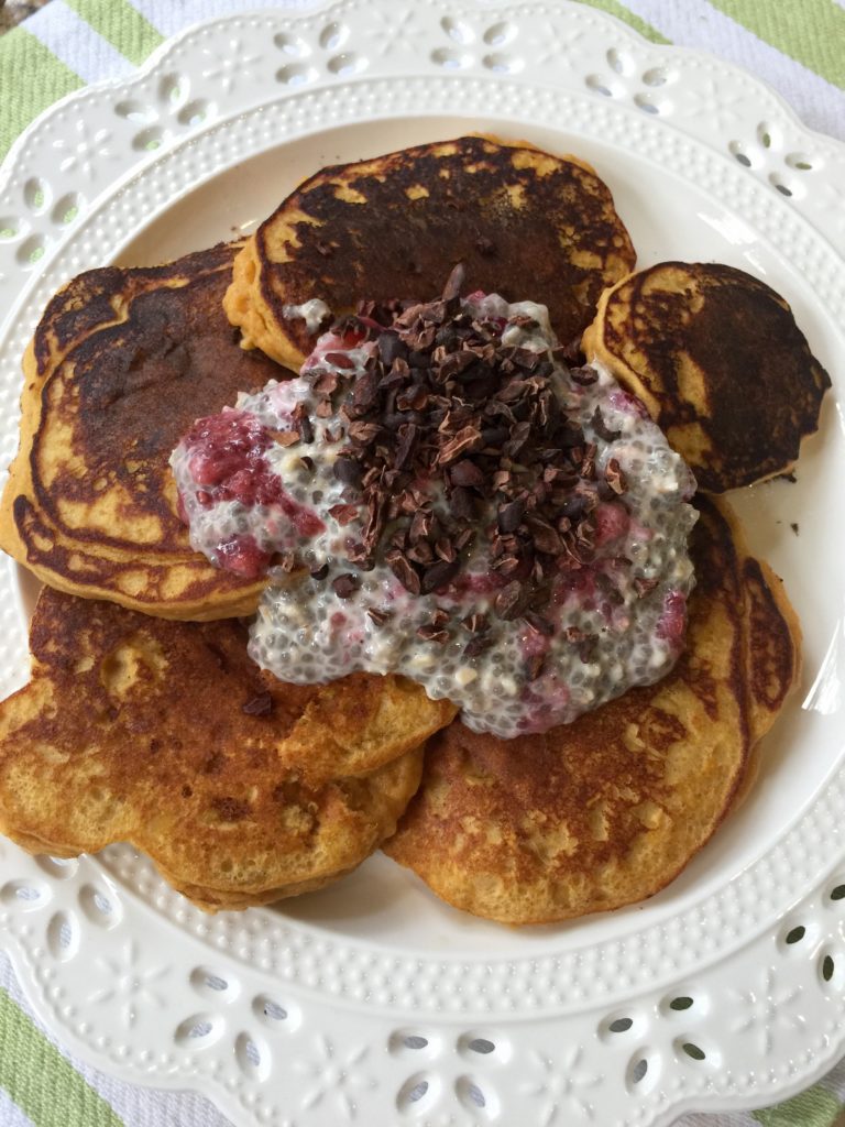 Afternoon snack: sweet potato pancakes with the rest of the chia pudding, strawberries, & more cacao nibs... SO yummy!