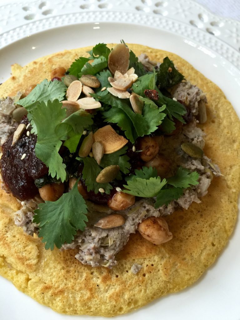 Chickpea pancake with artichoke dip, tomato chili jam, chickpeas, & cilantro