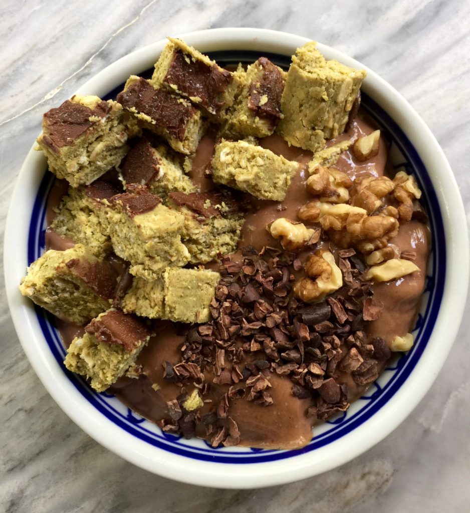 Chocolate banana smoothie bowl with walnuts, cacao nibs, & protein bar